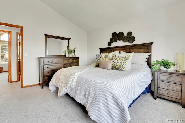 bedroom with baseboards, light colored carpet, and lofted ceiling
