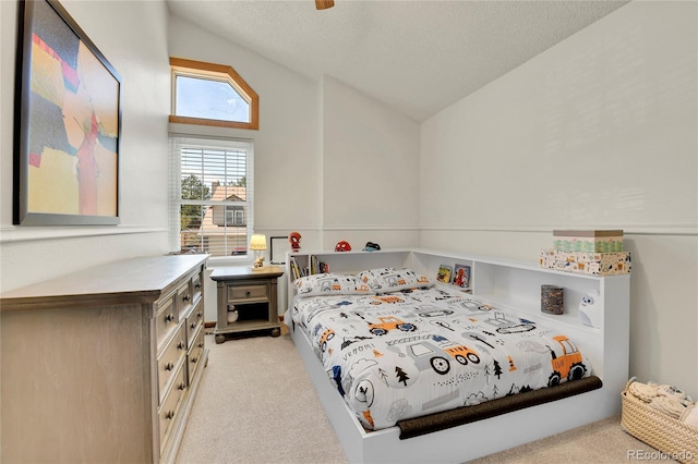 bedroom with light carpet, vaulted ceiling, and a textured ceiling