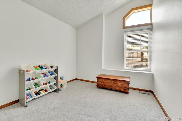 rec room featuring carpet floors, baseboards, and vaulted ceiling