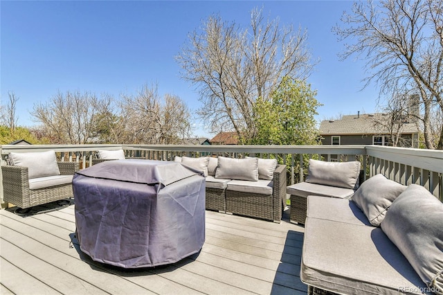wooden terrace with an outdoor hangout area