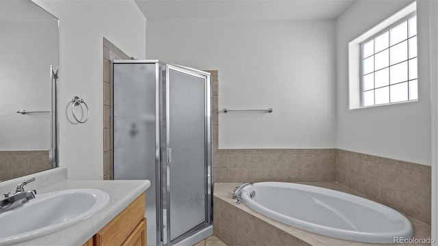 bathroom featuring a shower stall, a bath, and vanity