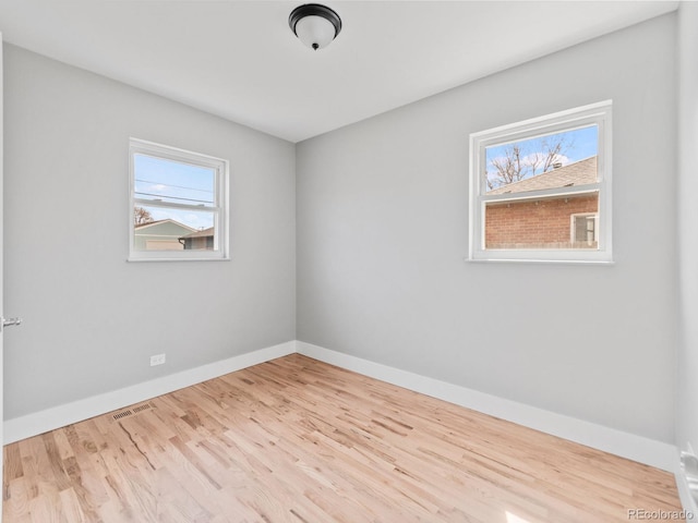 3630 Magnolia St, Denver, CO 80207 - empty room featuring healthy amount of natural light, baseboards, and wood finished floors