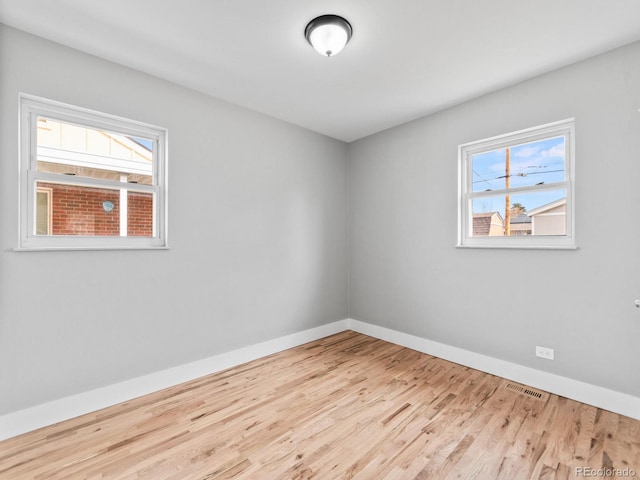 3630 Magnolia St, Denver, CO 80207 - spare room with wood finished floors, healthy amount of natural light, and baseboards