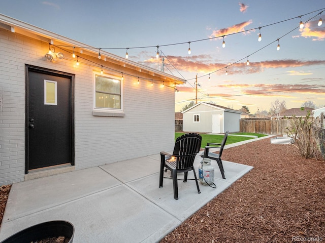 3630 Magnolia St, Denver, CO 80207 - patio terrace at dusk featuring fence and an outdoor structure