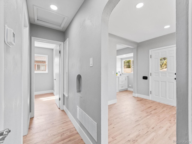 3630 Magnolia St, Denver, CO 80207 - corridor with attic access, baseboards, light wood-style floors, arched walkways, and recessed lighting