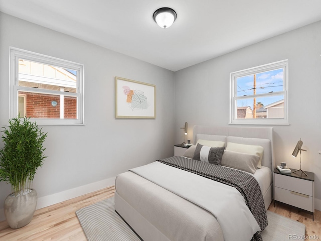 3630 Magnolia St, Denver, CO 80207 - bedroom featuring multiple windows, wood finished floors, and baseboards