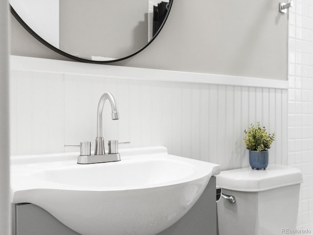 3630 Magnolia St, Denver, CO 80207 - bathroom with a wainscoted wall, toilet, and vanity