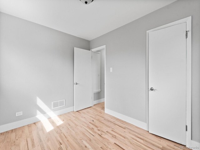3630 Magnolia St, Denver, CO 80207 - unfurnished bedroom featuring wood finished floors and baseboards