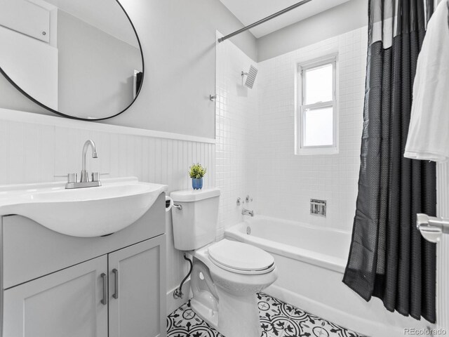 3630 Magnolia St, Denver, CO 80207 - bathroom featuring a wainscoted wall, toilet, shower / tub combo with curtain, and vanity