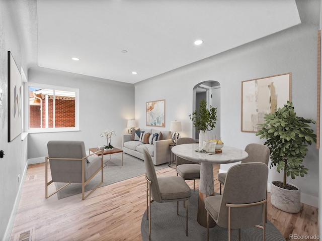 3630 Magnolia St, Denver, CO 80207 - dining space with arched walkways, light wood-style floors, recessed lighting, and baseboards