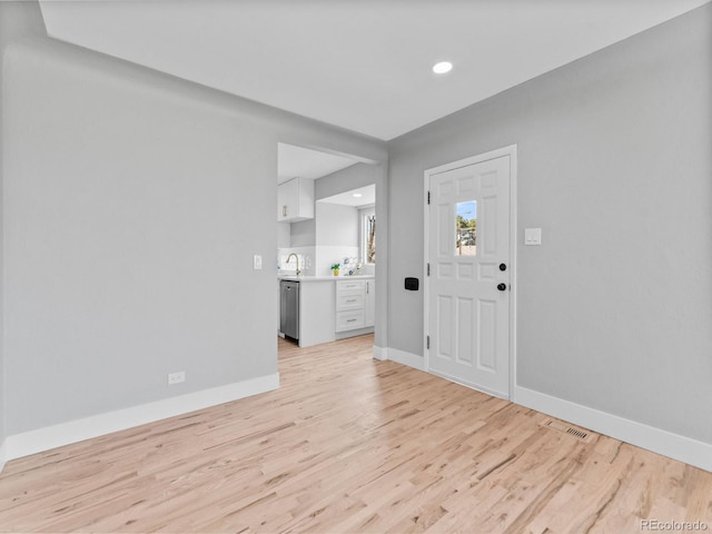 3630 Magnolia St, Denver, CO 80207 - foyer entrance with light wood finished floors, baseboards, and recessed lighting