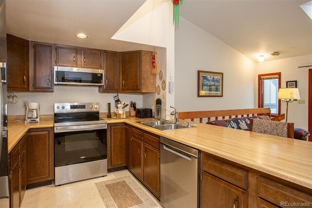 324 W Main St, Frisco, CO 80443 - kitchen featuring stainless steel appliances, a sink, light countertops, lofted ceiling, and recessed lighting