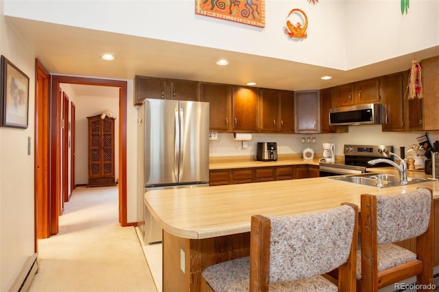 324 W Main St, Frisco, CO 80443 - kitchen with stainless steel appliances, light countertops, a baseboard heating unit, a peninsula, and a sink