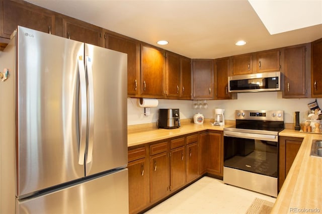 324 W Main St, Frisco, CO 80443 - kitchen featuring stainless steel appliances, light countertops, recessed lighting, and brown cabinetry