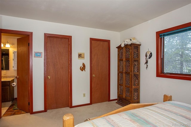 324 W Main St, Frisco, CO 80443 - bedroom featuring light colored carpet, two closets, connected bathroom, and baseboards