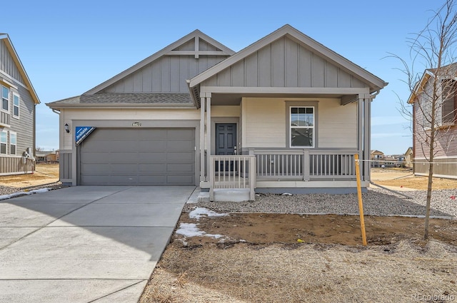 view of front of property with a porch, an attached garage, concrete driveway, roof with shingles, and board and batten siding