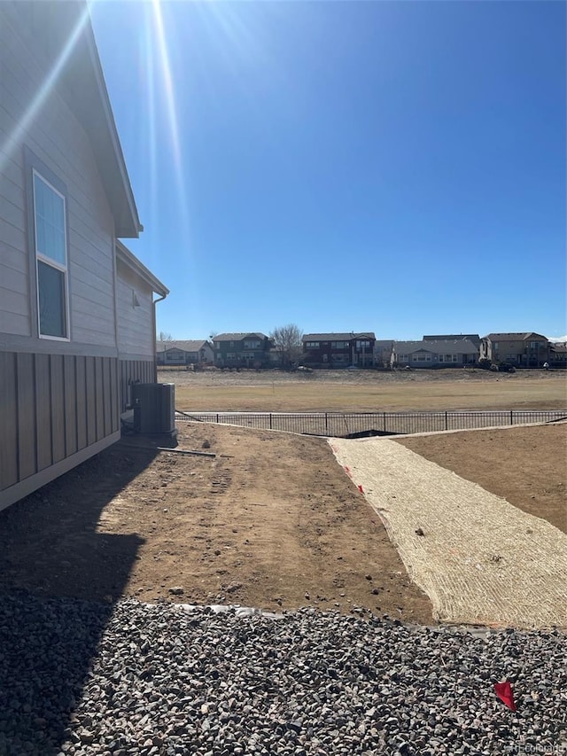 view of yard with fence and cooling unit