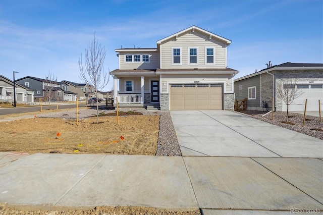 view of front of home featuring stone siding, a porch, a residential view, concrete driveway, and a garage