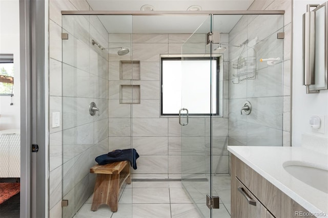 bathroom featuring a stall shower, connected bathroom, vanity, and tile patterned floors