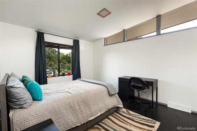bedroom featuring dark wood-type flooring and baseboards