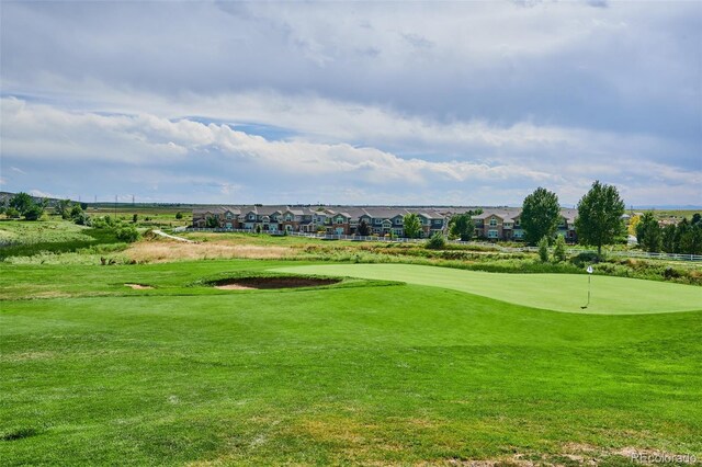 2197 S Jackson Gap St, Aurora, CO 80018 - view of community with a putting area, view of golf course, and a lawn