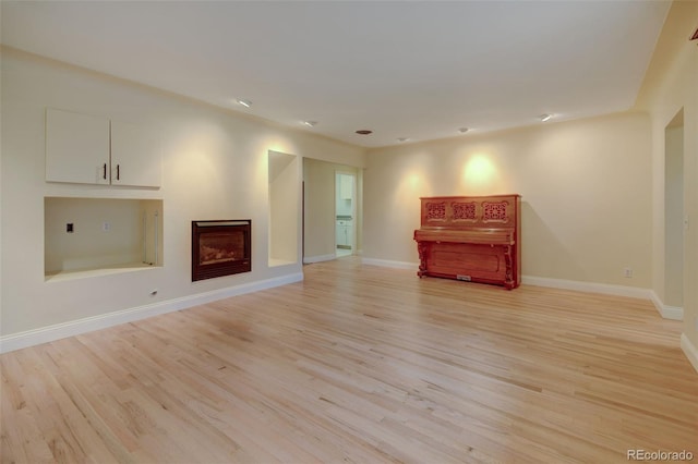 1275 Fairfax St, Denver, CO 80220 - unfurnished living room with light wood-type flooring and a fireplace