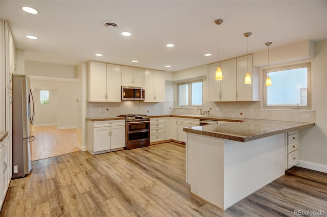1275 Fairfax St, Denver, CO 80220 - kitchen with stainless steel appliances, a peninsula, light wood-type flooring, white cabinets, and recessed lighting