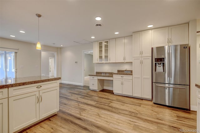 1275 Fairfax St, Denver, CO 80220 - kitchen with stainless steel fridge with ice dispenser, recessed lighting, white cabinetry, glass insert cabinets, and light wood-style flooring