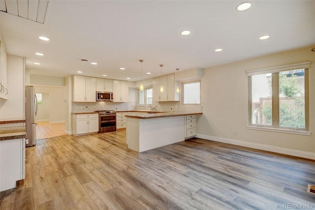 1275 Fairfax St, Denver, CO 80220 - kitchen with stainless steel appliances, white cabinetry, recessed lighting, a peninsula, and healthy amount of natural light