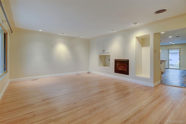 1275 Fairfax St, Denver, CO 80220 - unfurnished living room with light wood-style floors and recessed lighting