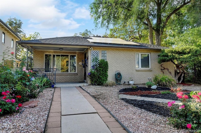1275 Fairfax St, Denver, CO 80220 - bungalow-style home with brick siding, covered porch, and solar panels