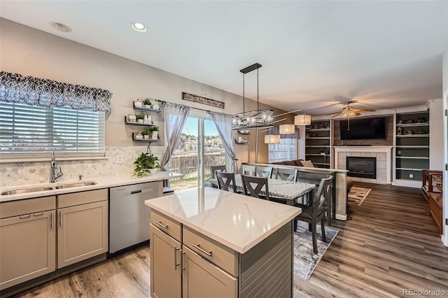 12362 Nate Cir, Parker, CO 80134 - kitchen with stainless steel dishwasher, a sink, ceiling fan, light wood finished floors, and gray cabinets