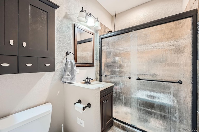 12362 Nate Cir, Parker, CO 80134 - full bathroom with toilet, a stall shower, a textured wall, and vanity