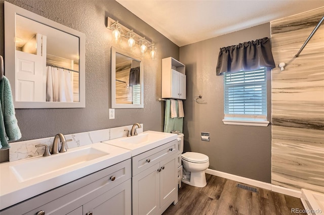 12362 Nate Cir, Parker, CO 80134 - bathroom with a textured wall, wood finished floors, double vanity, toilet, and a shower with curtain