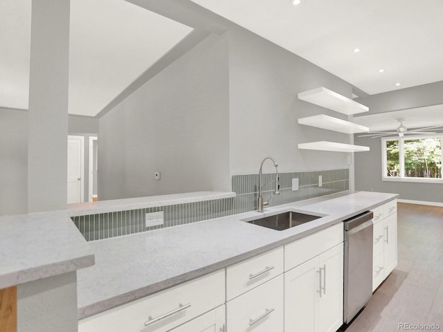 2046 S Quitman St, Denver, CO 80219 - kitchen with stainless steel dishwasher, backsplash, light stone counters, open shelves, and light wood-style flooring