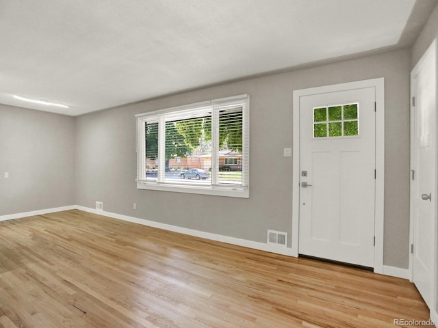 2046 S Quitman St, Denver, CO 80219 - foyer entrance featuring healthy amount of natural light and light wood-style floors