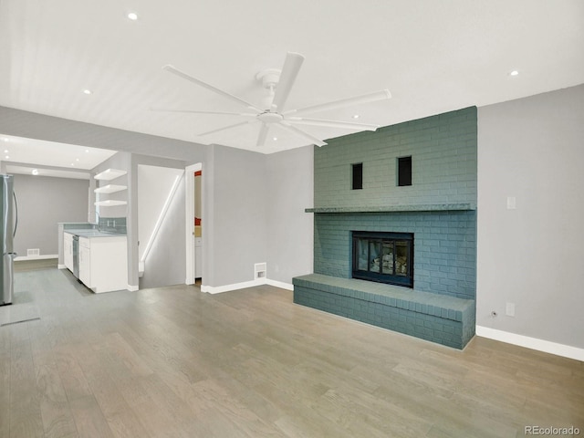 2046 S Quitman St, Denver, CO 80219 - unfurnished living room featuring wood finished floors, ceiling fan, recessed lighting, and a fireplace