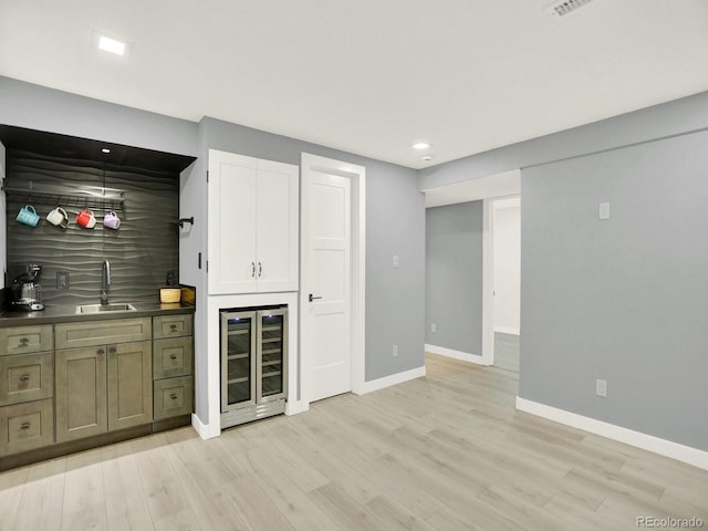 2046 S Quitman St, Denver, CO 80219 - bar featuring wine cooler, light wood-style floors, and recessed lighting