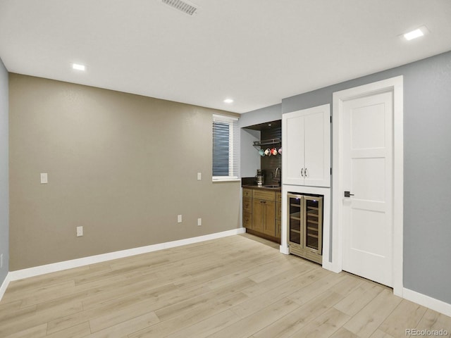 2046 S Quitman St, Denver, CO 80219 - indoor wet bar featuring wine cooler, light wood-style floors, and recessed lighting