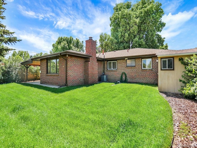 2046 S Quitman St, Denver, CO 80219 - rear view of house featuring a chimney and brick siding