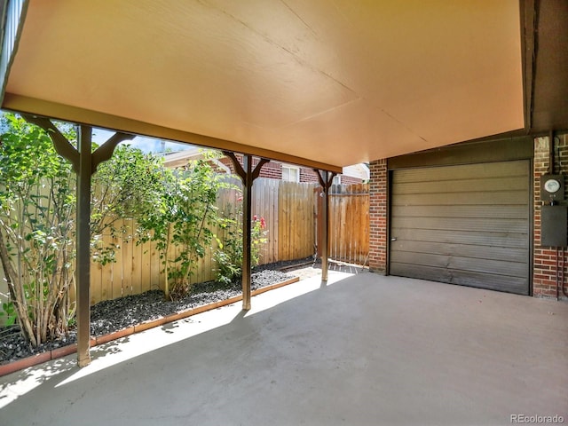 2046 S Quitman St, Denver, CO 80219 - view of patio / terrace featuring an attached garage and driveway