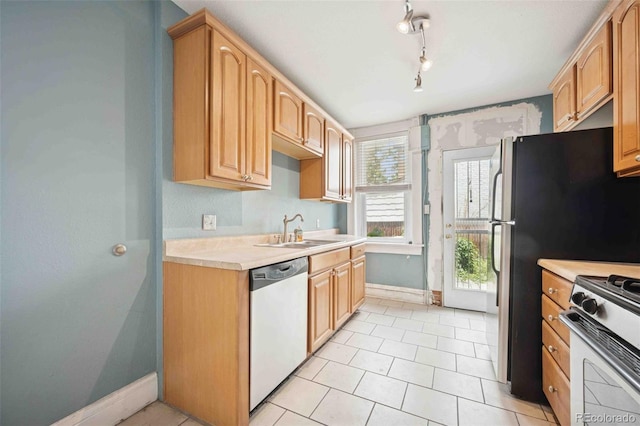 709 27th St, Denver, CO 80205 - kitchen with stainless steel appliances, a sink, baseboards, and light countertops