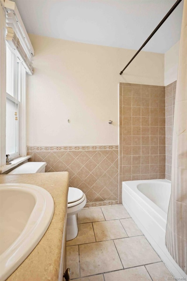709 27th St, Denver, CO 80205 - bathroom featuring toilet, tile walls, vanity,  shower combination, and a wainscoted wall