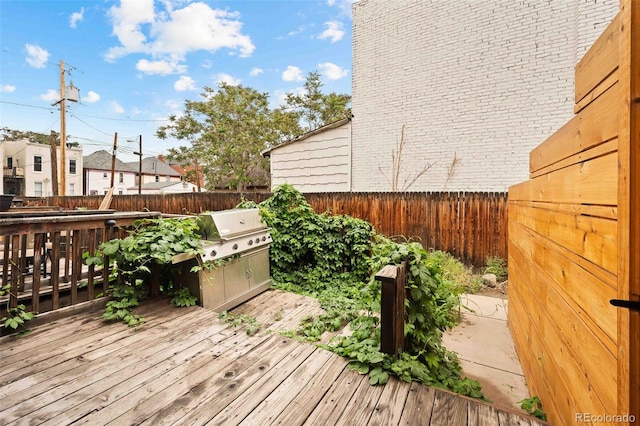 709 27th St, Denver, CO 80205 - wooden terrace featuring a grill and a fenced backyard