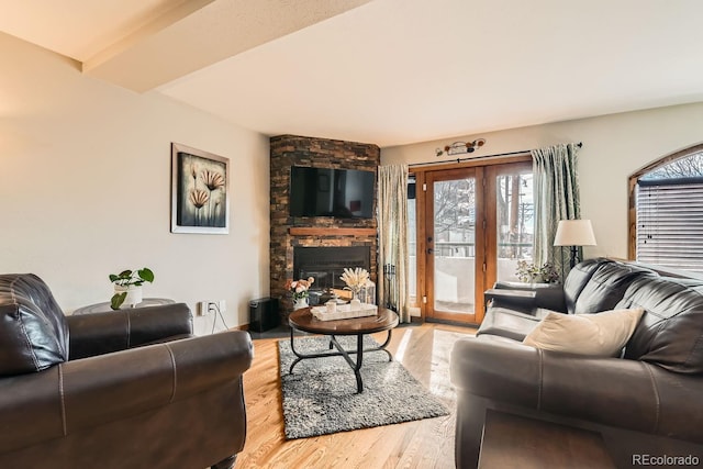 living room with hardwood / wood-style floors and a fireplace