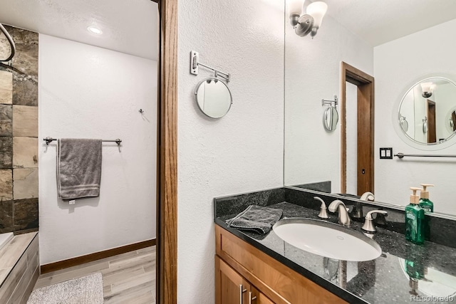 bathroom featuring hardwood / wood-style flooring and vanity