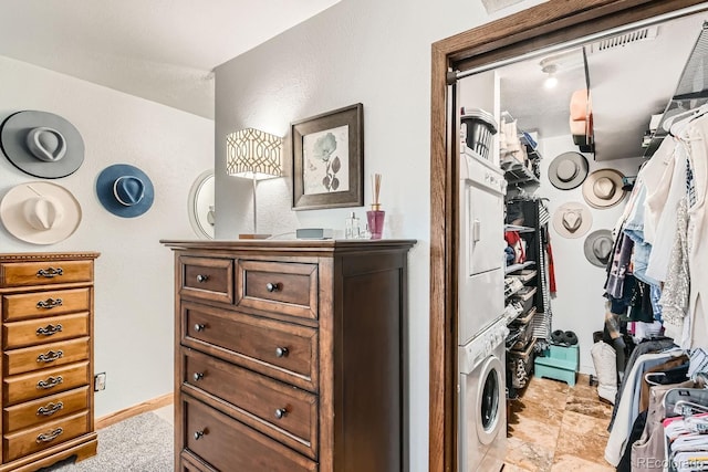 interior space featuring stacked washing maching and dryer