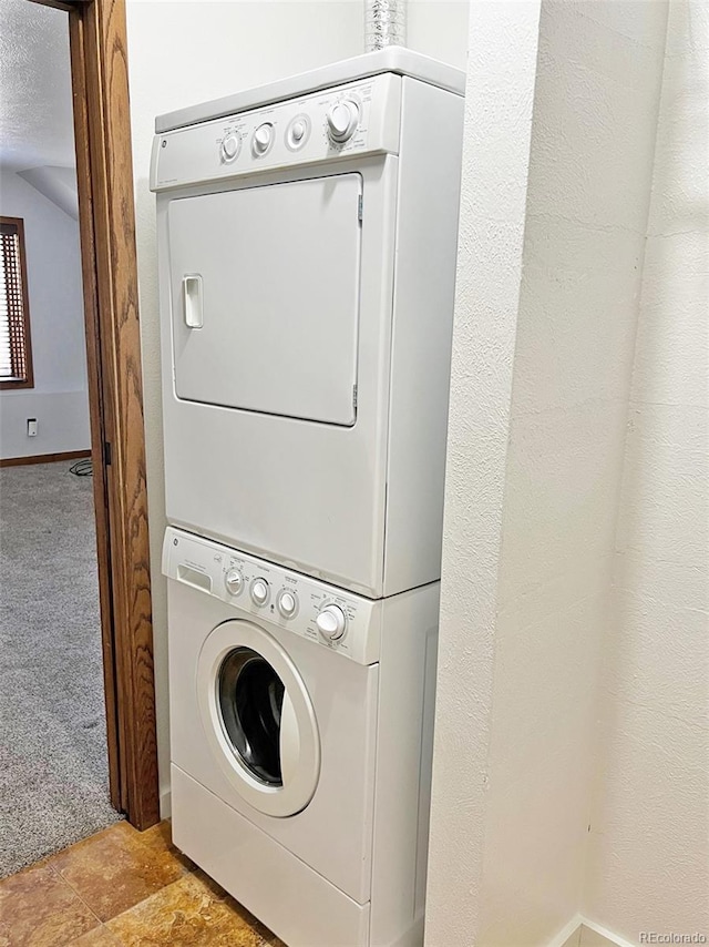 611 E 7th Ave, Denver, CO 80203 - washroom featuring laundry area, stacked washer and clothes dryer, baseboards, and light colored carpet