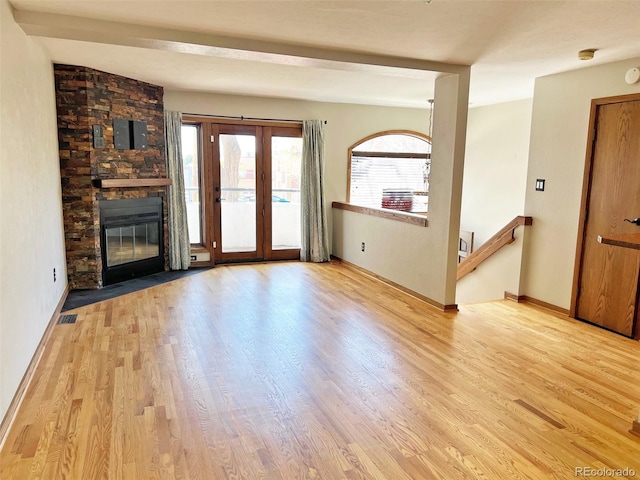 611 E 7th Ave, Denver, CO 80203 - unfurnished living room featuring baseboards, wood finished floors, and a fireplace