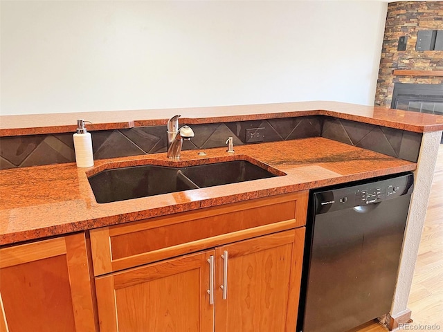 611 E 7th Ave, Denver, CO 80203 - kitchen with a sink, a fireplace, light countertops, dishwasher, and light wood-style flooring